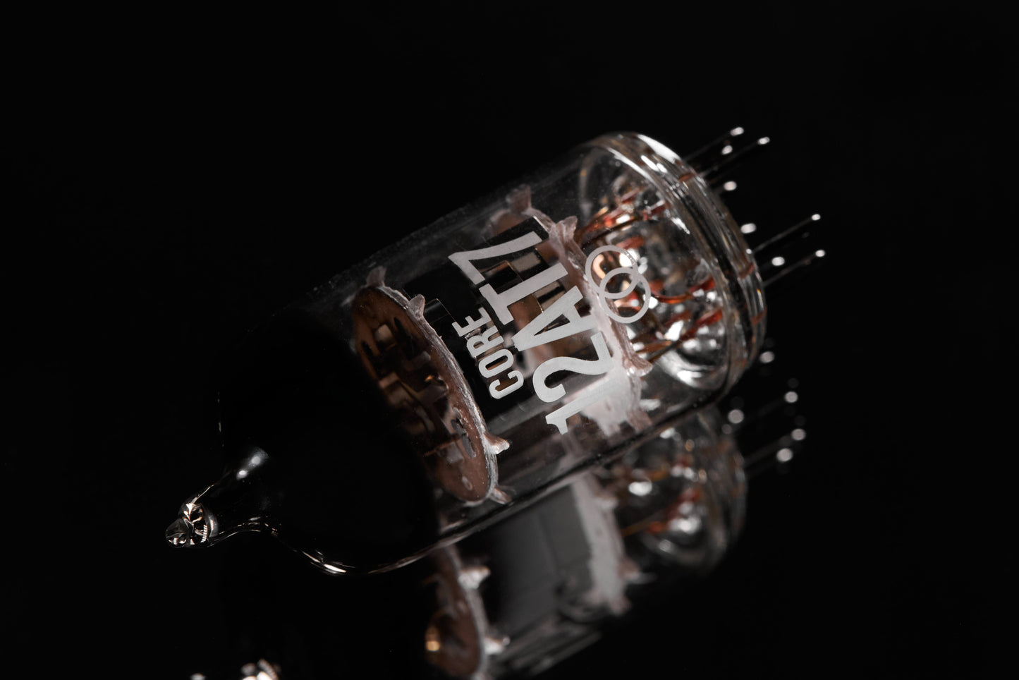 Close-up of a glass tube with metallic components on a black background
