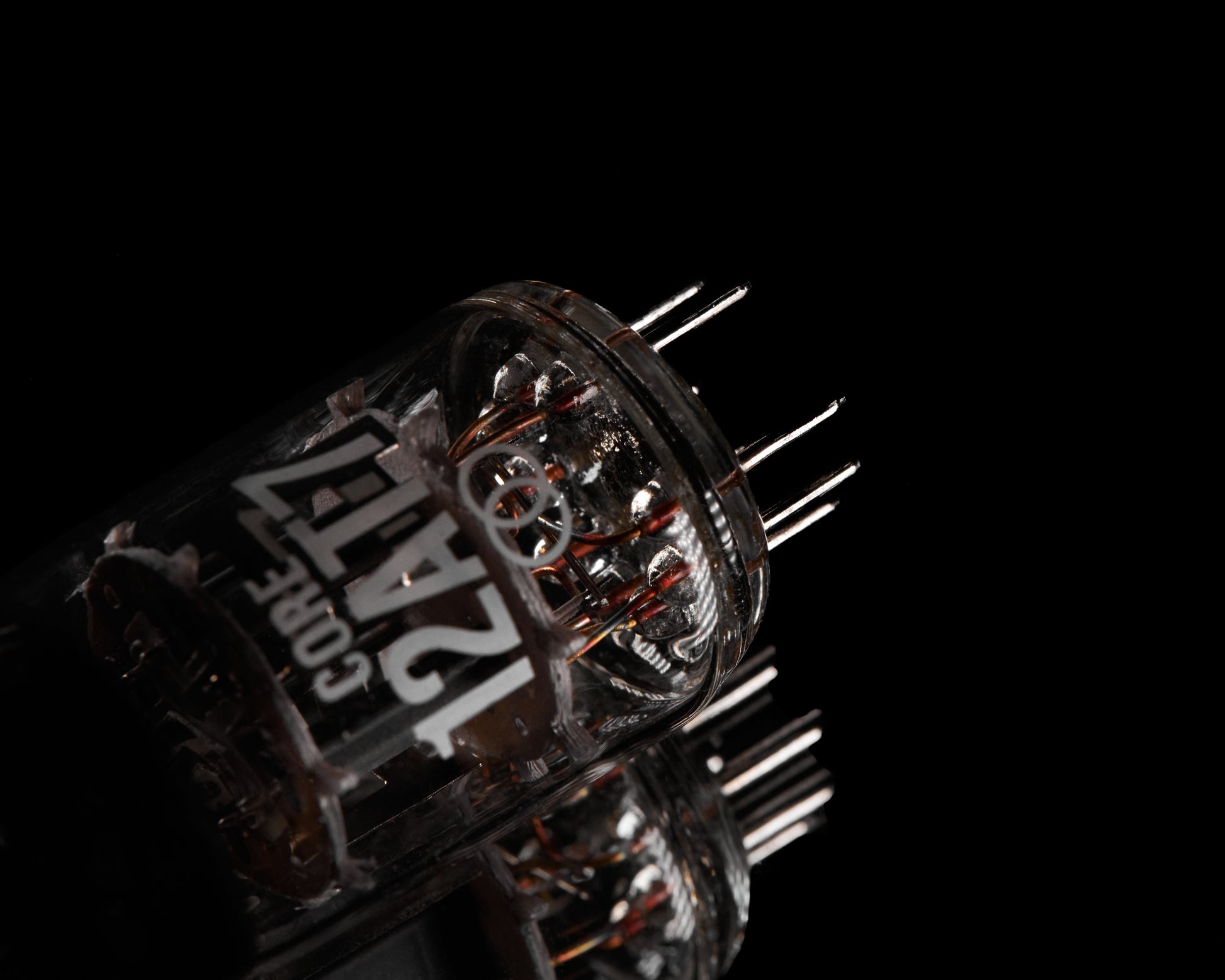 Close-up of a electronic component with 'CORE 12AT7' branding on a black background