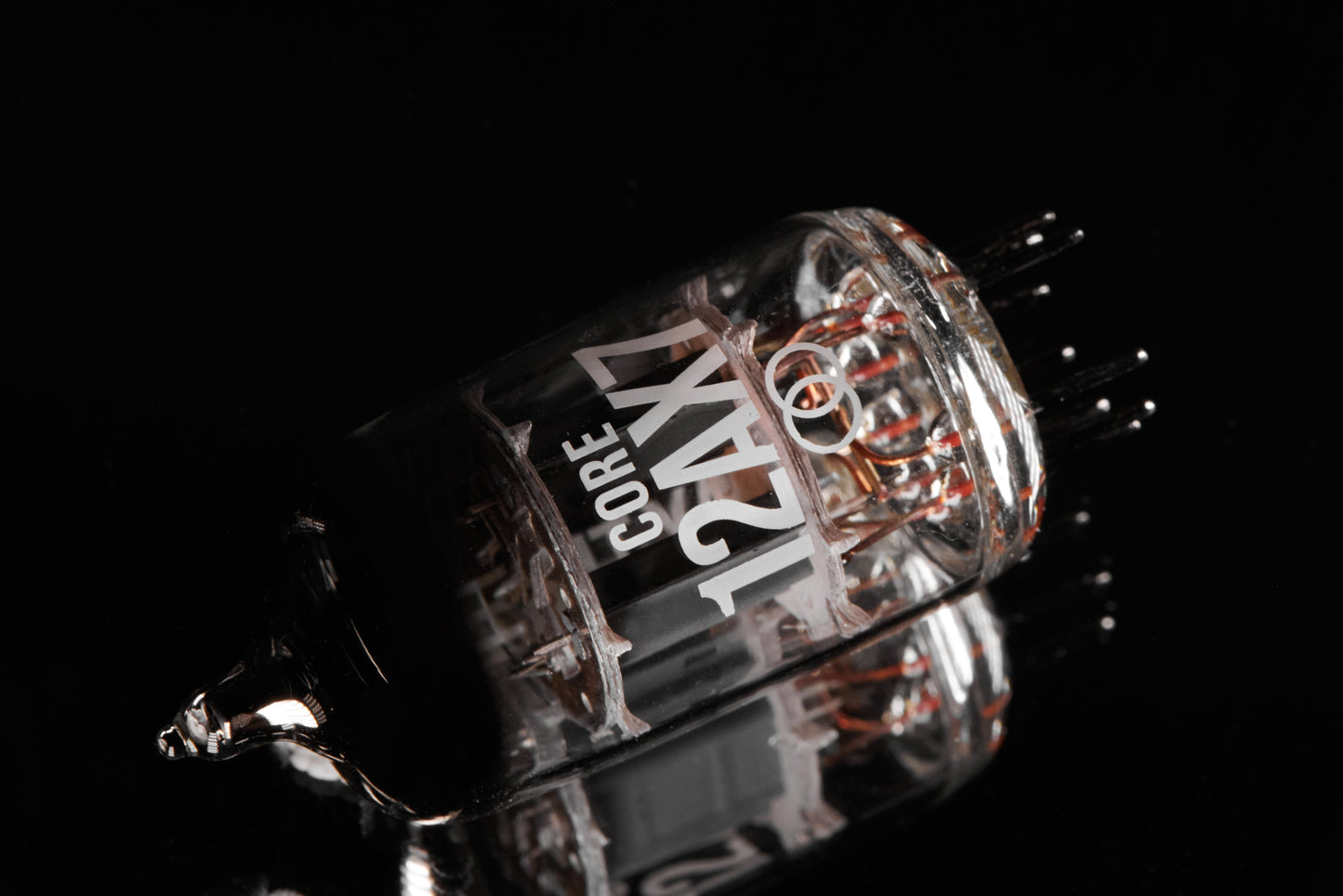 Close-up of a vacuum tube with 'CORE 12AX7' branding on a black background