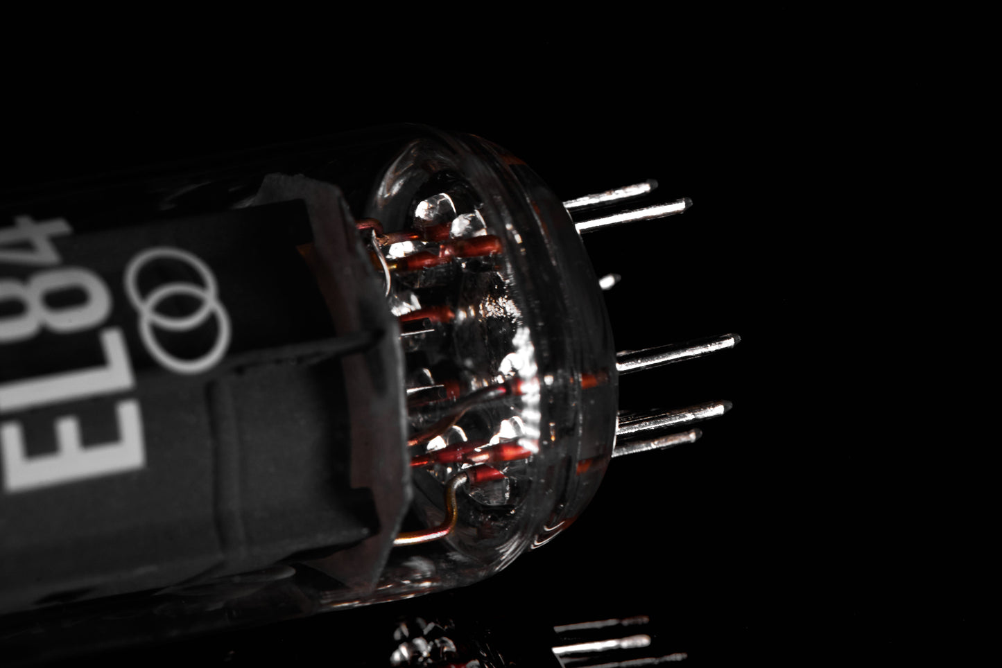 Close-up of a vacuum tube with visible branding on a black background