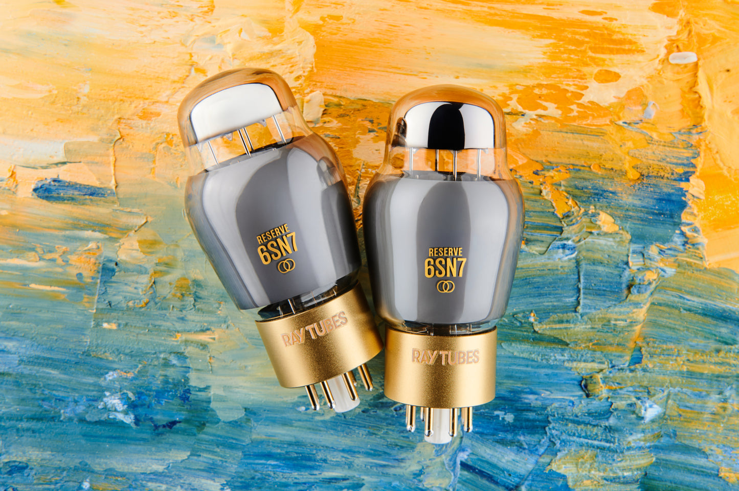 Two vacuum tubes with gold bases on a colorful abstract background