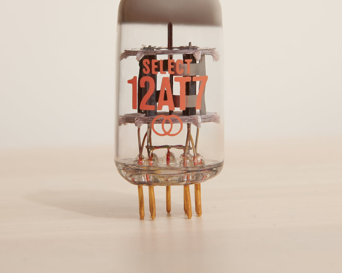 Vacuum tube with 'SELECT 12AT7' text on a beige background