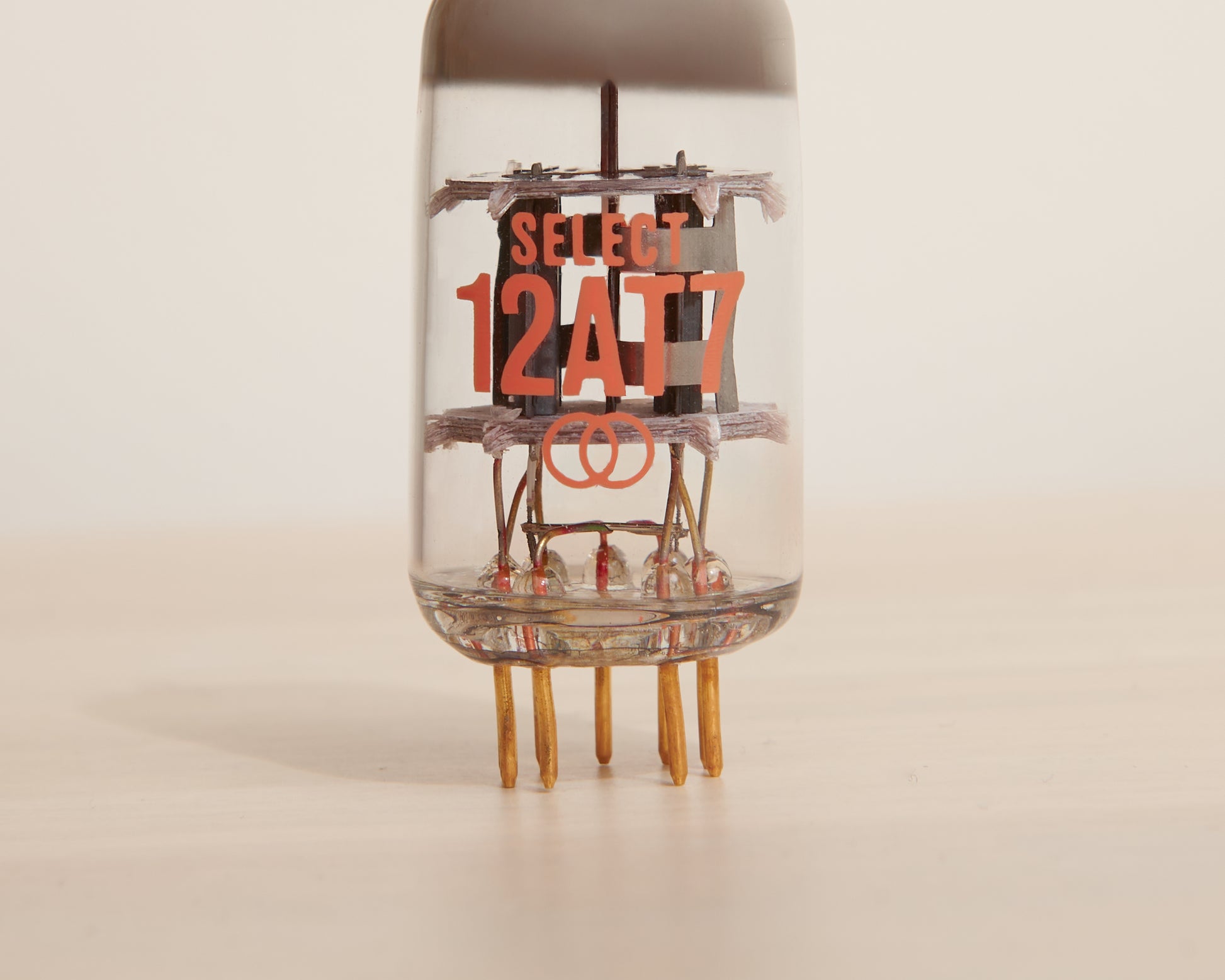 Vacuum tube with 'SELECT 12AT7' text on a beige background