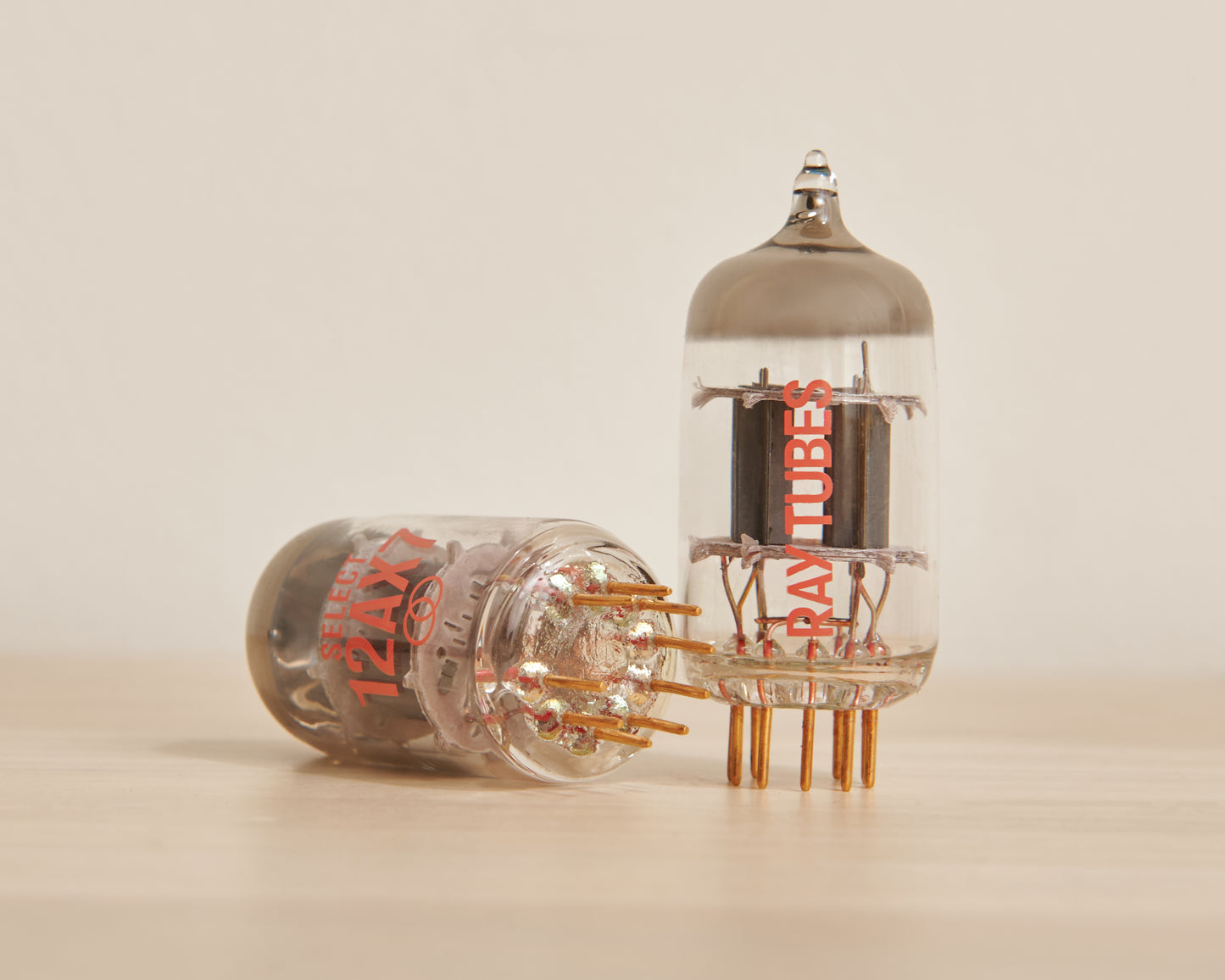 Two vacuum tubes with 'Ray Tubes' branding on a beige background