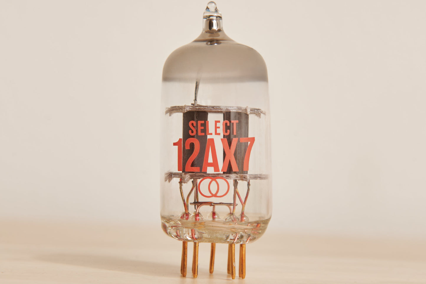 Vacuum tube with 'SELECT 12AX7' label on a beige background