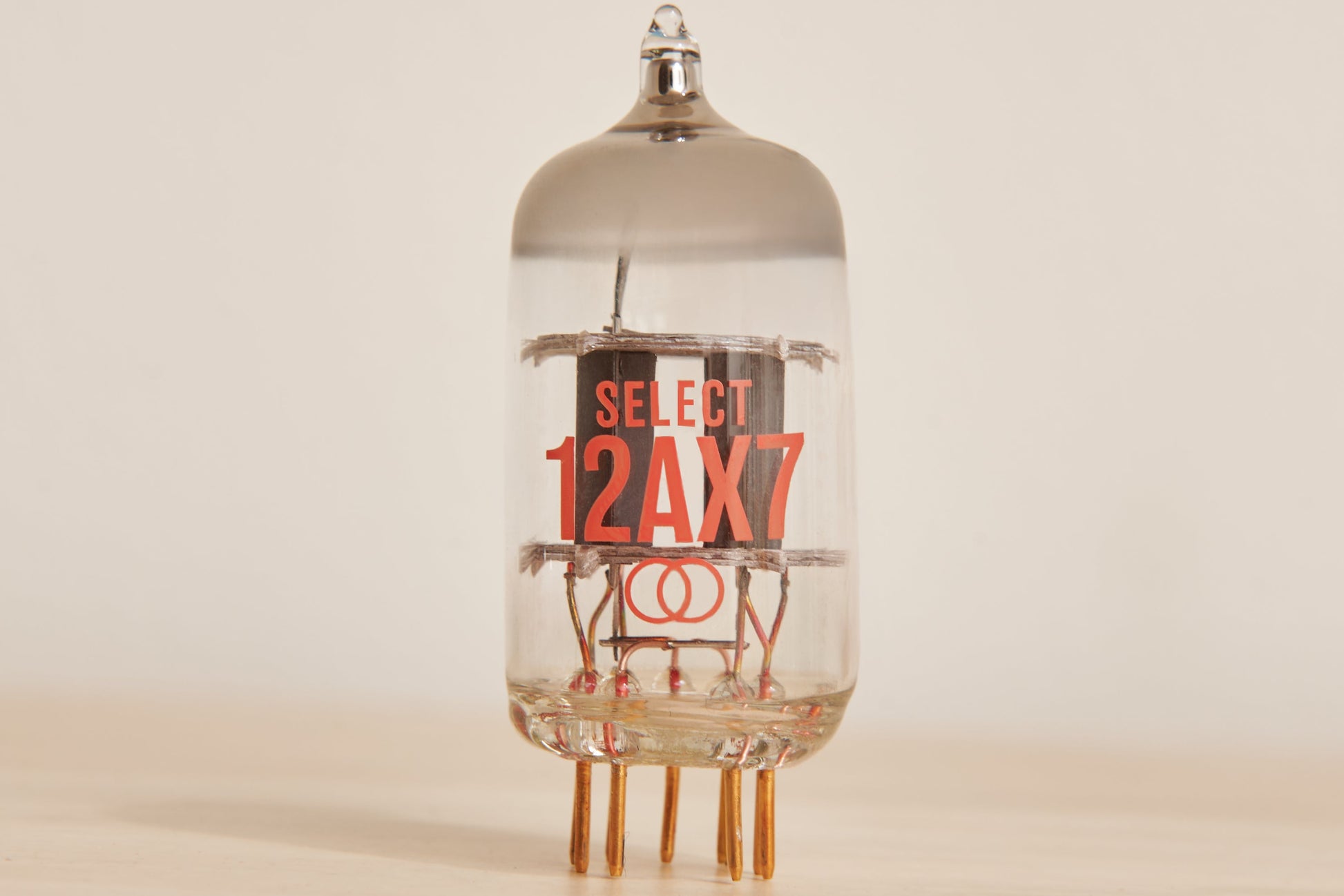 Vacuum tube with 'SELECT 12AX7' label on a beige background