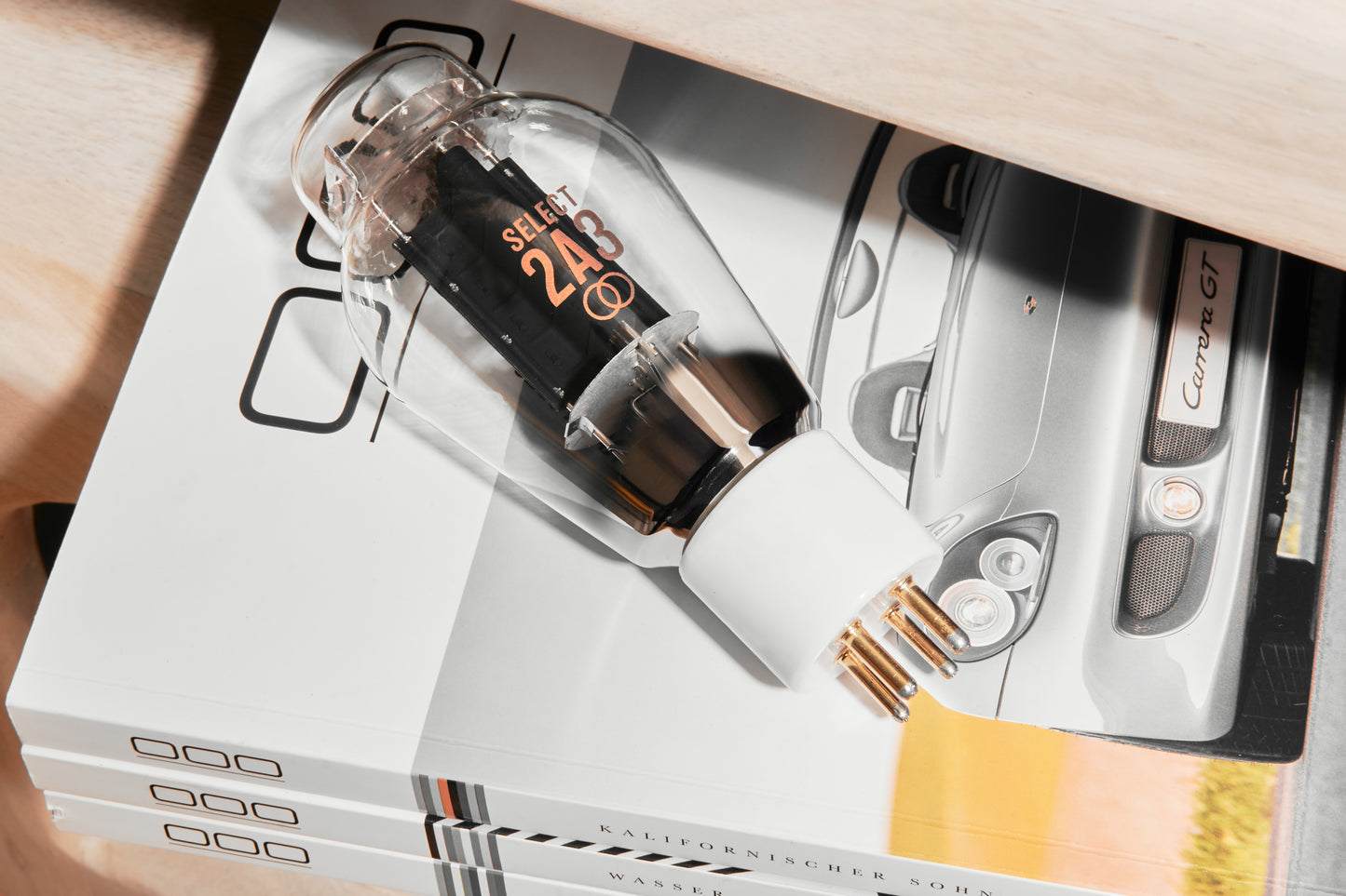 Close-up of a glass bottle with a dropper on top of a magazine