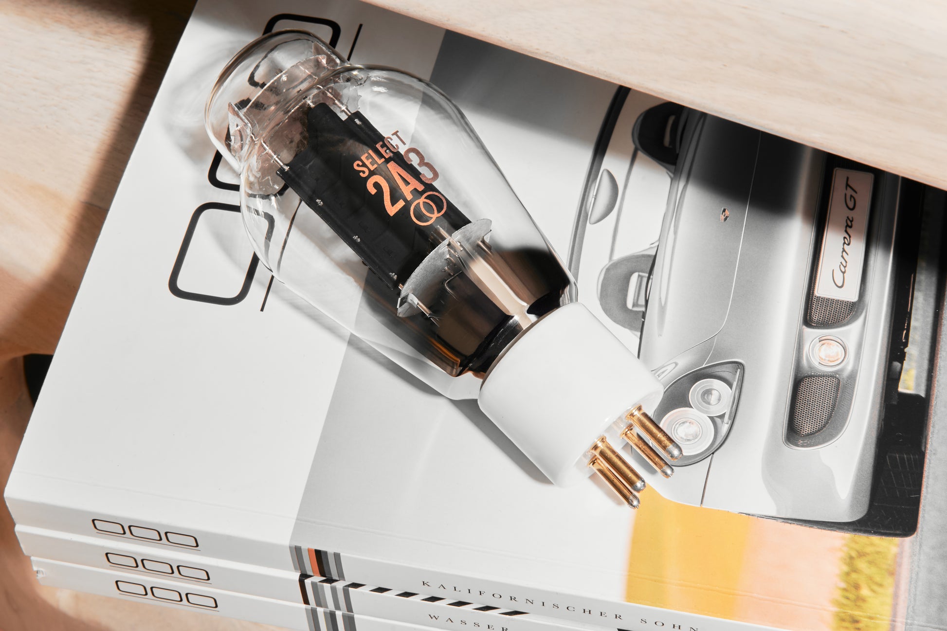Close-up of a glass bottle with a dropper on top of a magazine