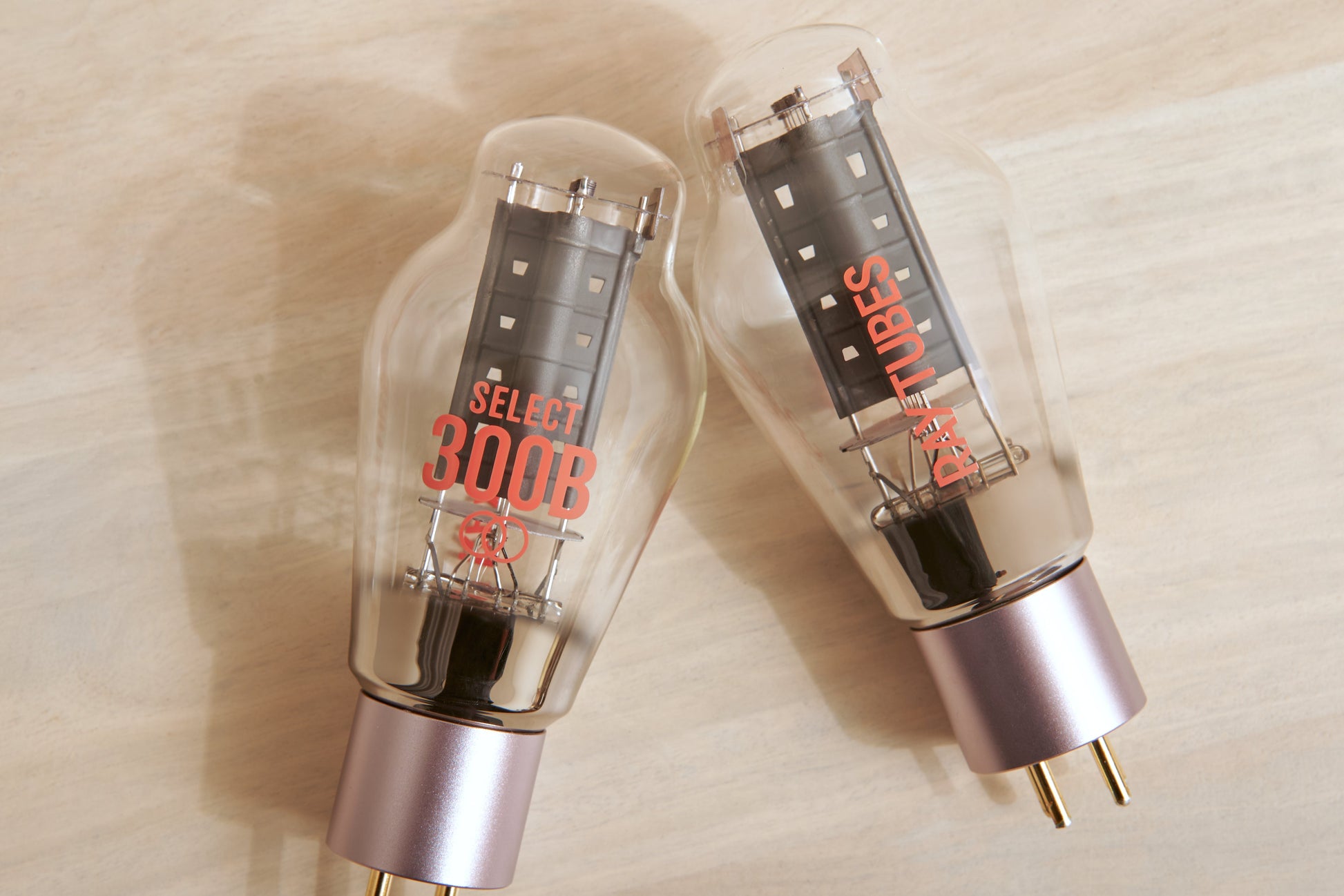 Two vacuum tubes with 'Ray Tubes' branding on a wooden surface