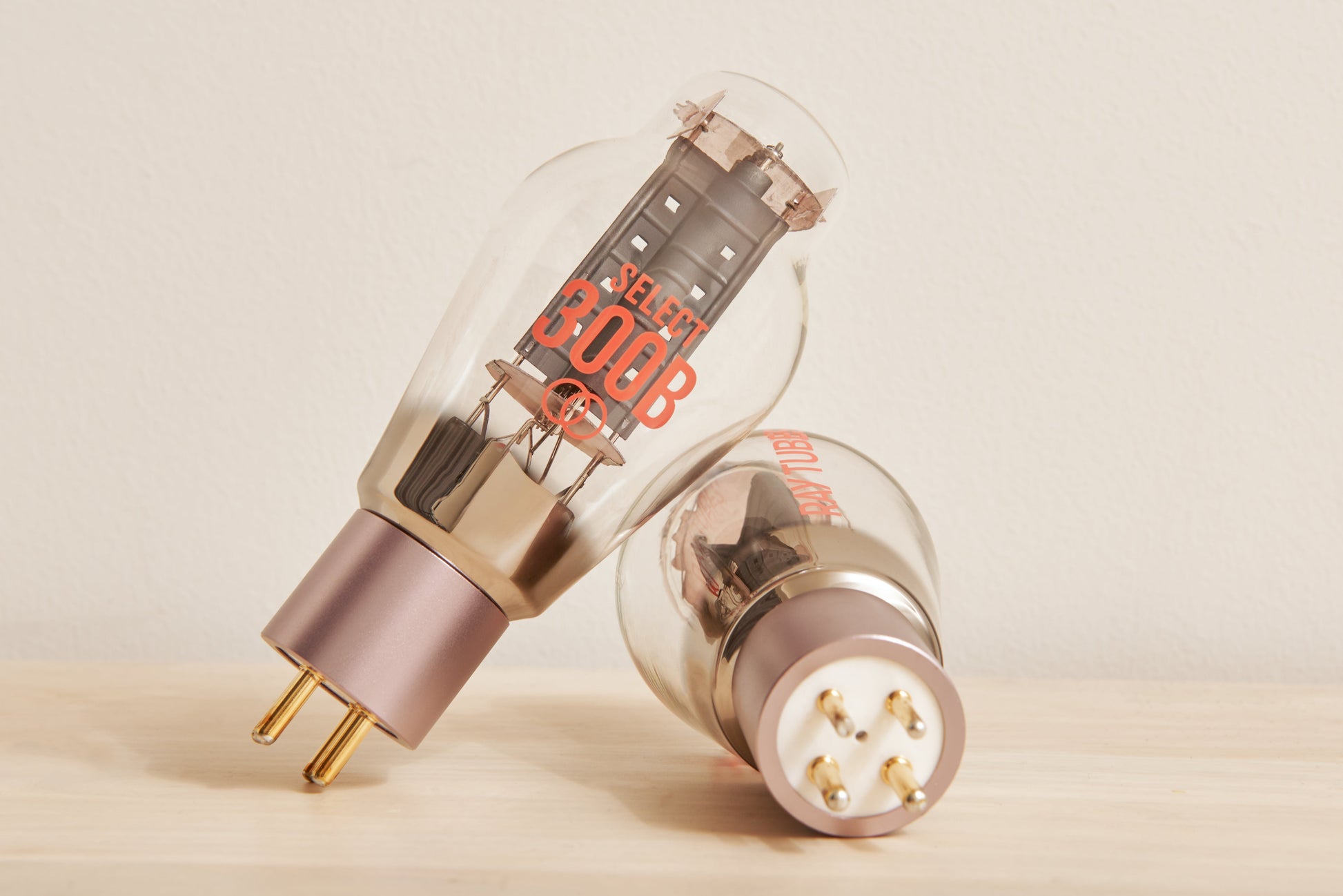 Two vacuum tubes with visible branding on a beige background