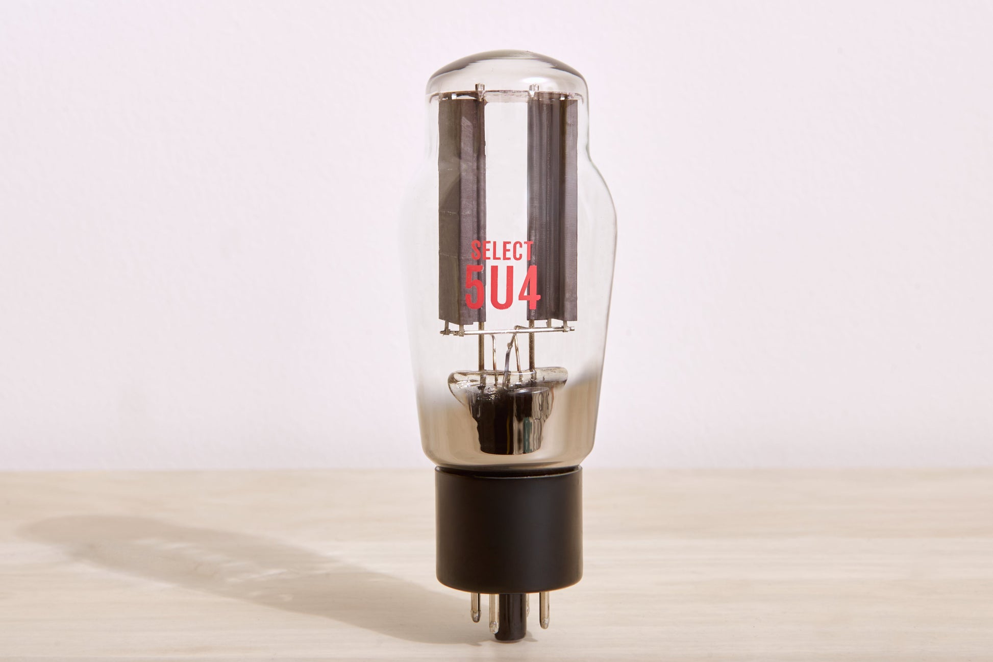 Vacuum tube on a wooden surface with a neutral background