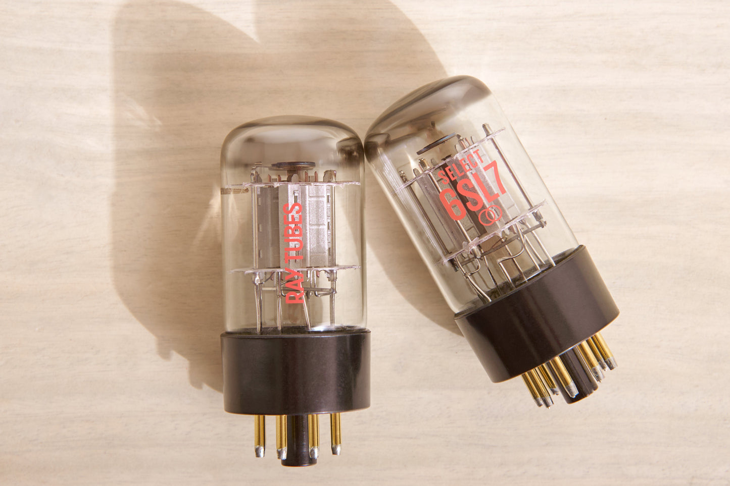 Two vacuum tubes on a beige background