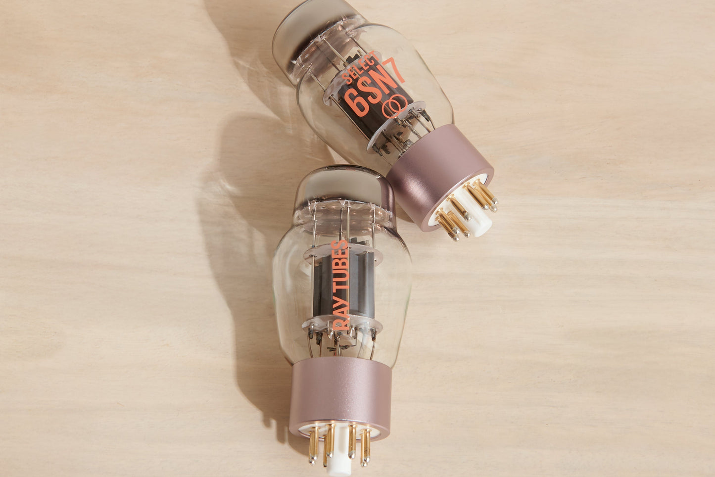 Two vacuum tubes with 'Ray Tubes' branding on a beige background