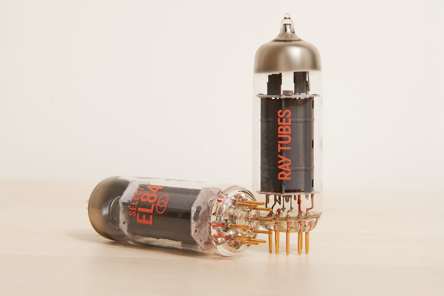 Two vacuum tubes with 'Ray Tubes' branding on a beige background