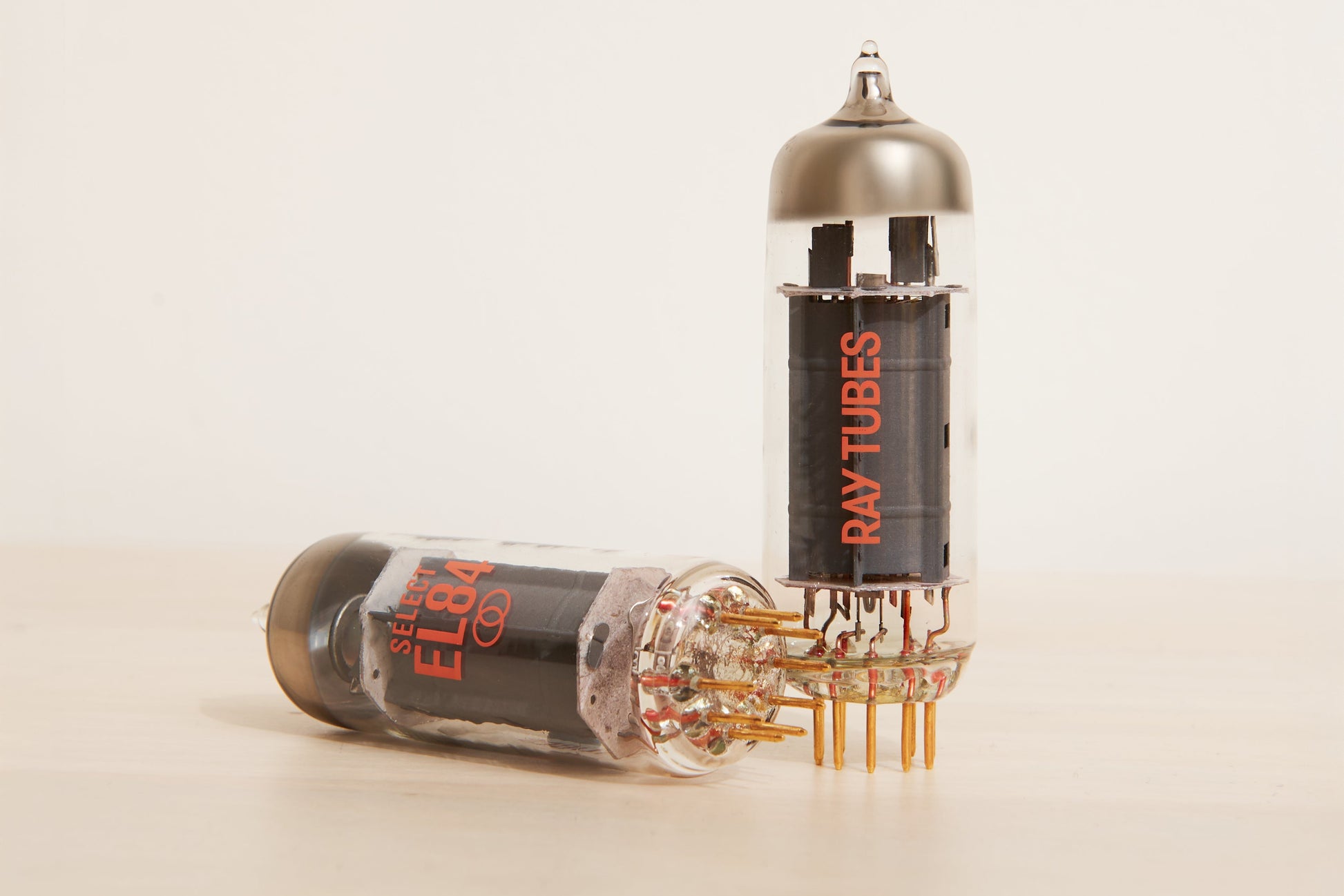 Two vacuum tubes with 'Ray Tubes' branding on a beige background