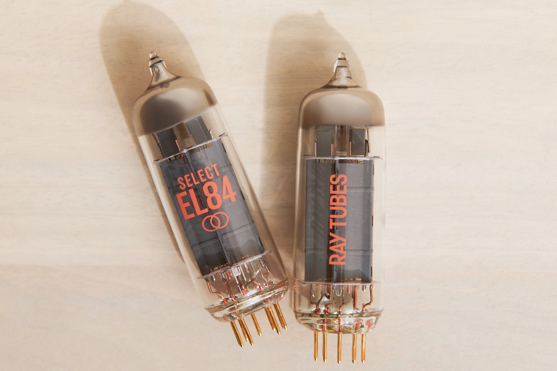 Two vacuum tubes with 'Ray Tubes' branding on a beige background