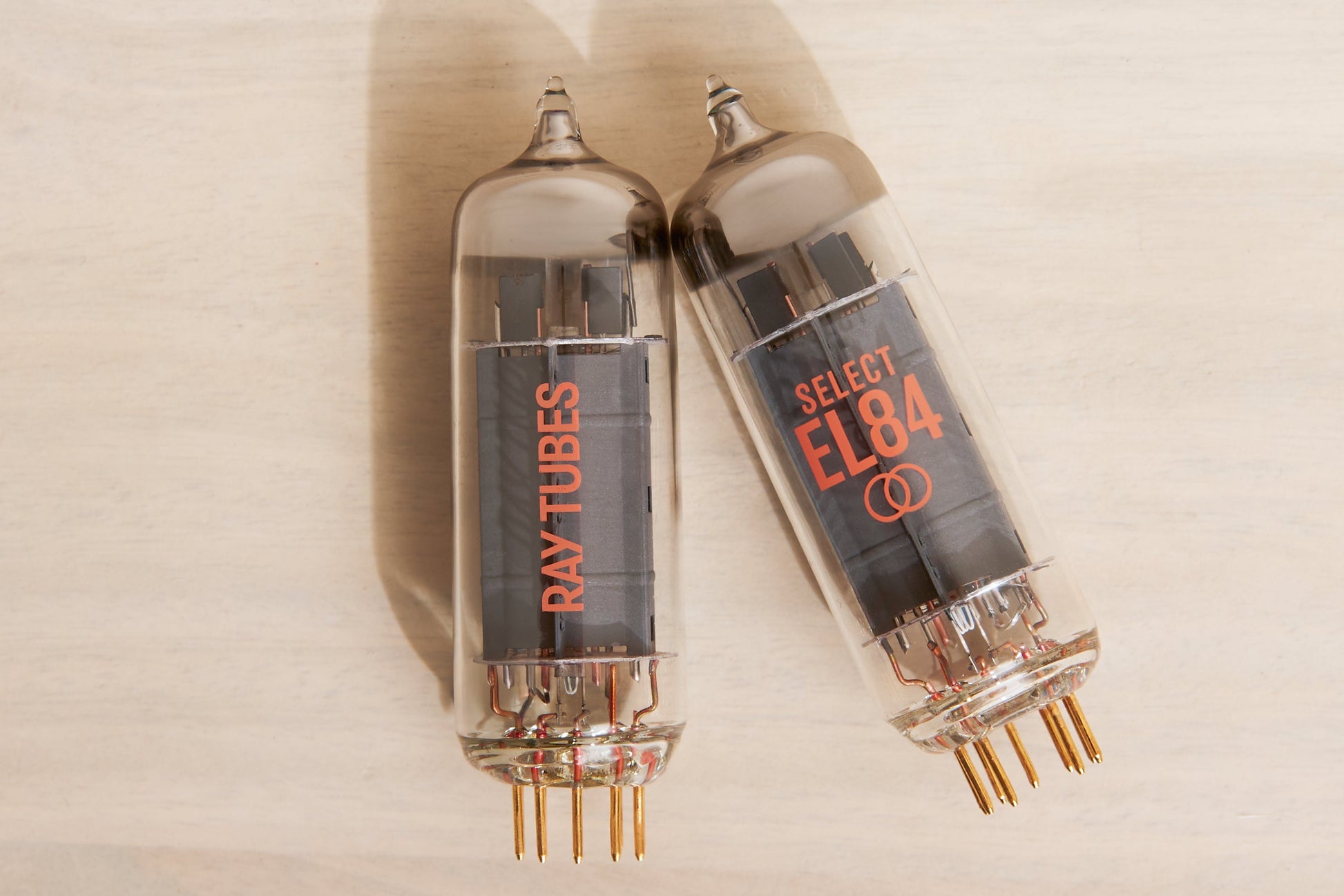 Two vacuum tubes with 'Ray Tubes' branding on a beige background