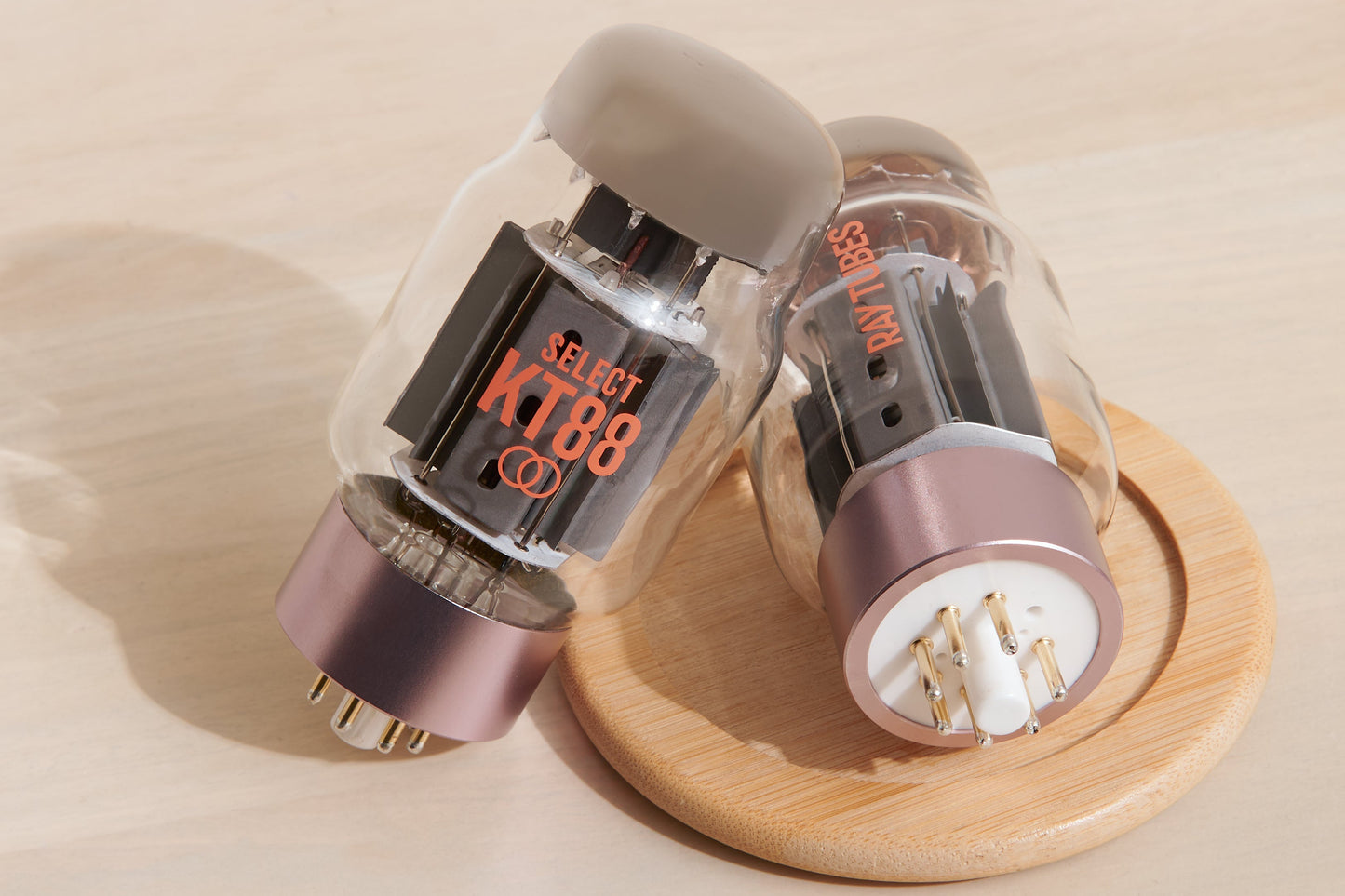 Two vacuum tubes on a wooden coaster with a beige background