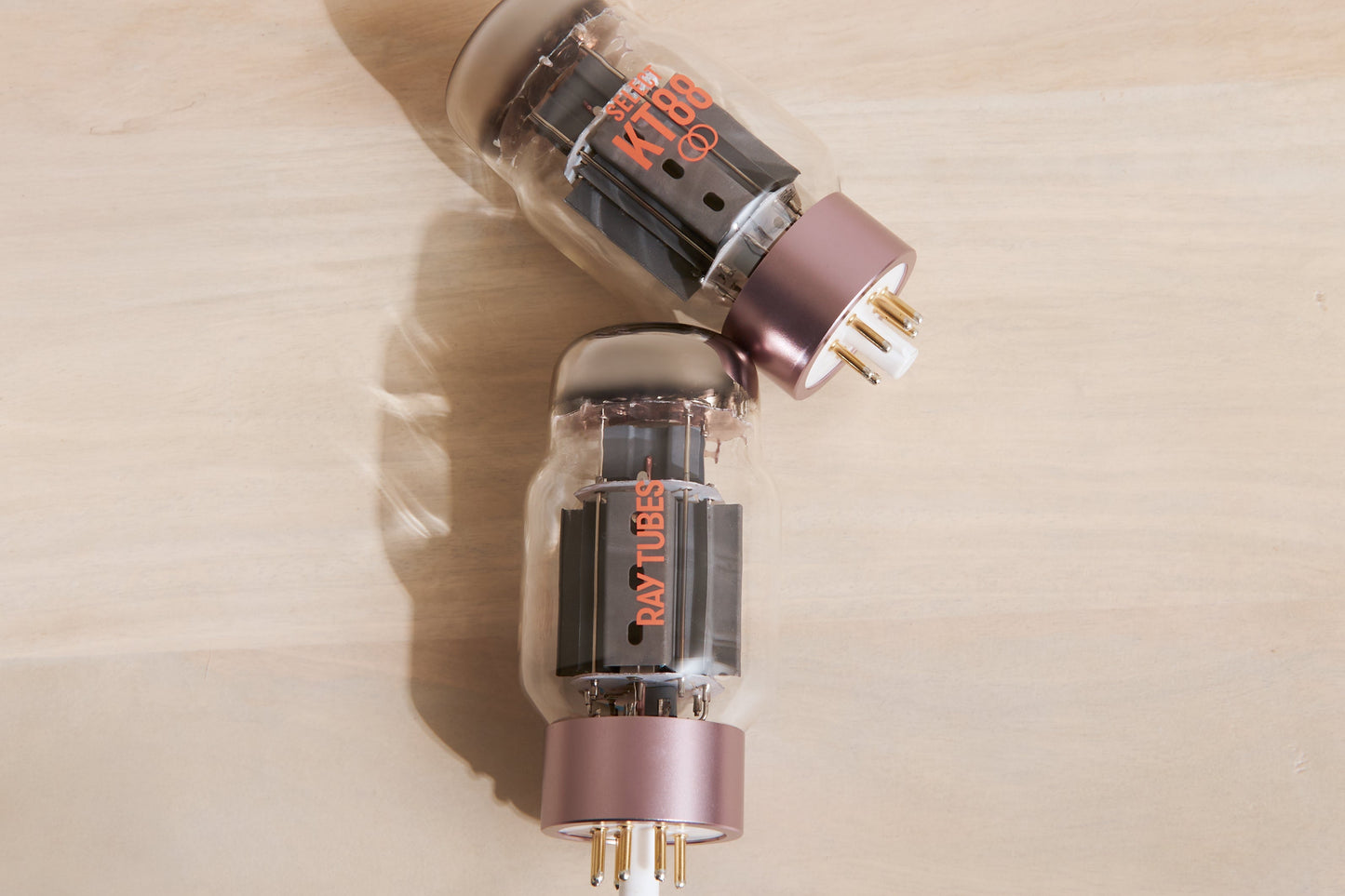 Two vacuum tubes with 'Ray Tubes' branding on a beige surface