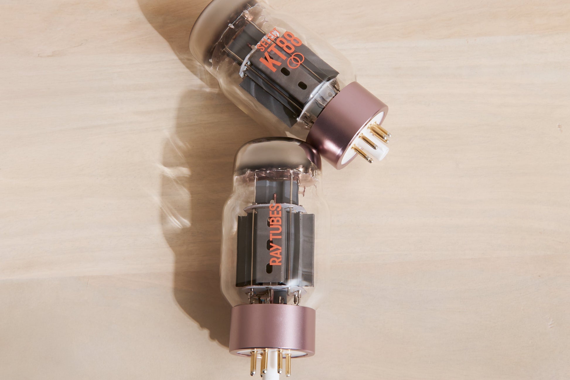 Two vacuum tubes with 'Ray Tubes' branding on a beige surface